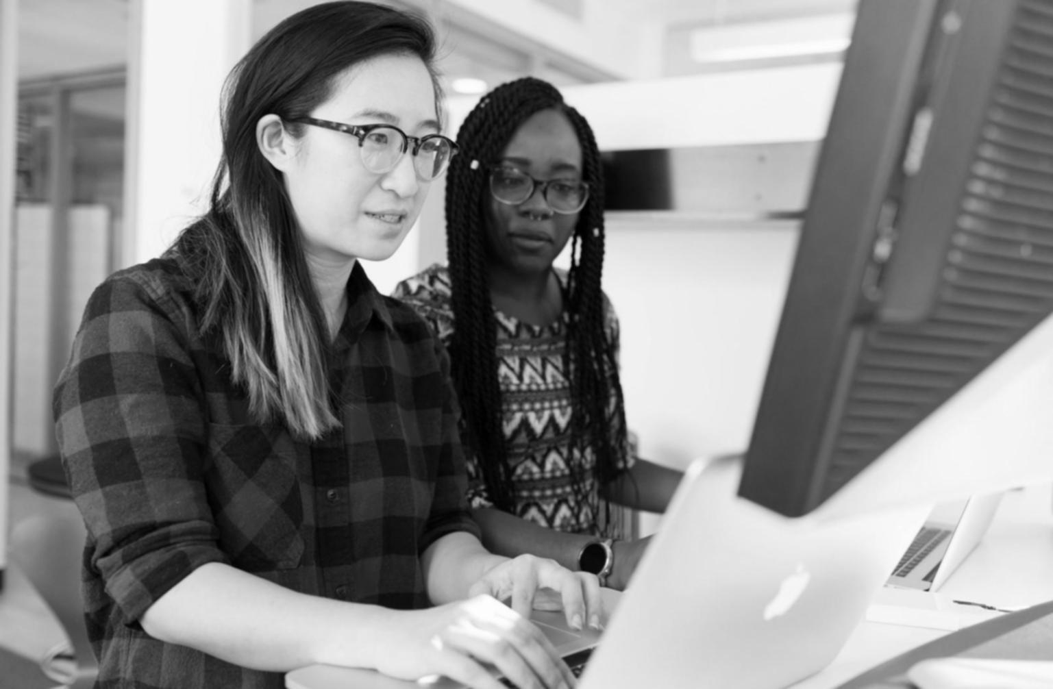 Detailed planning session with business stakeholders reviewing website wireframes and user experience flows